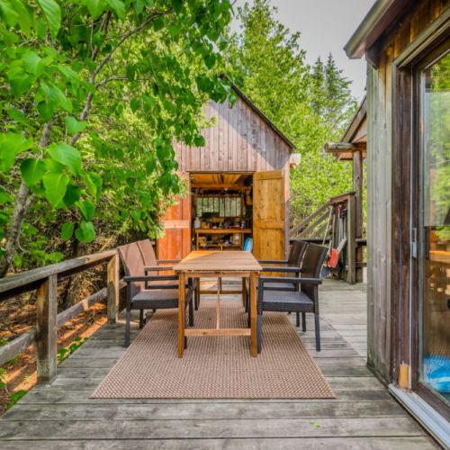 The wraparound deck provides ample space for outdoor dining, relaxation, and taking in the stunning sunsets over the horizon.