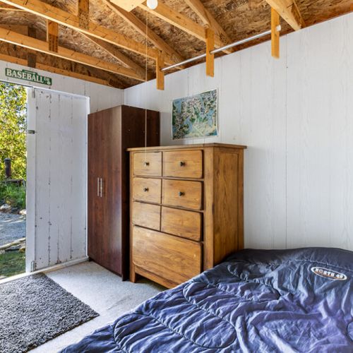 Another view of the cozy bunkhouse, complete with direct outdoor access and rustic charm.