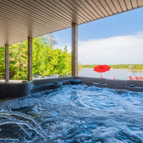 The hot tub is easily accessible off the waterfront and lower level lounge.