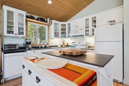 The fully equipped kitchen has everything you need to prepare meals, with plenty of counter space and beautiful forest views from the sink.