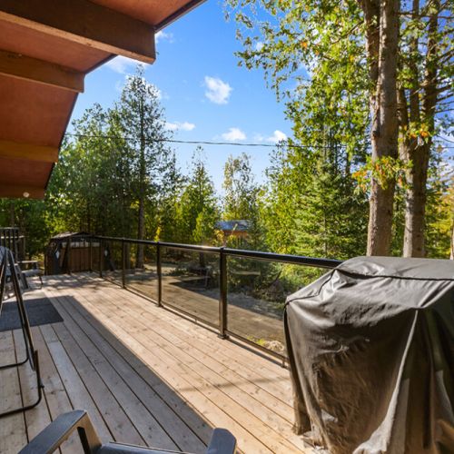 Fire up the BBQ and enjoy outdoor dining on the spacious deck surrounded by peaceful woodland views.