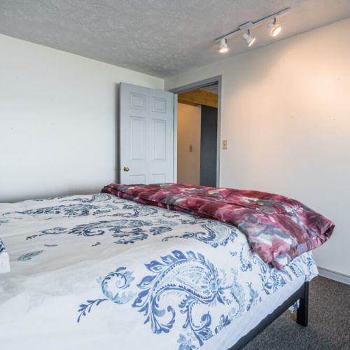 A serene bedroom with fresh decor and direct access to outdoor views.