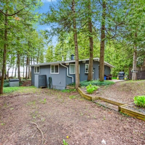 Welcome to Summer Side! Tucked beneath a canopy of cedar trees, this charming lakefront cottage invites you to unwind in nature while enjoying all the comforts of home.