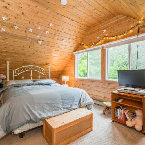 The upper floor guest bedroom provides the perfect spot to relax, with plenty of space for kids to play.