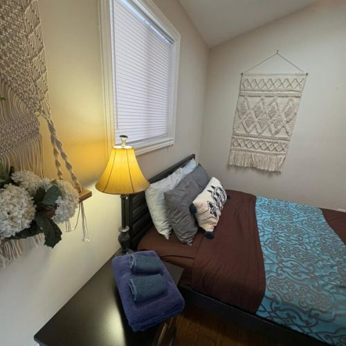 A warm, inviting bedroom with comfortable bedding and natural light. Perfect for restful nights after exploring the region and enjoying cottage travel.