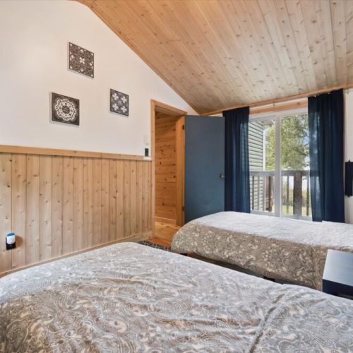 Bedroom 2: Comfortable bedroom with natural wood finishes, creating a calm and restful atmosphere.