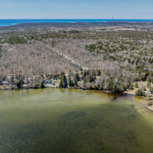 Scenic lakeside community with beautiful wooded landscapes and clear waters. A hidden gem for peaceful cottage stays near sandy beaches and nature trails!