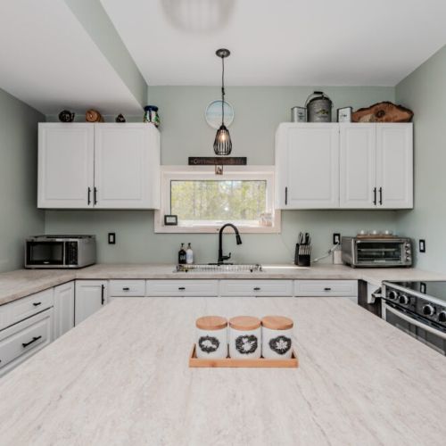 Charming and functional, this cottage kitchen boasts bright windows, rustic decor, and all the essentials for cooking up comfort during your stay.