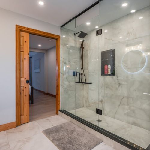 Enjoy the gorgeous marble shower with rainfall shower head. The walk-in provide a luxurious touch to the bathroom, combining modern design with the tranquility of a personal spa retreat.