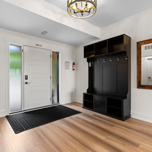 A welcoming entryway provides plenty of space to store coats, shoes, and gear.