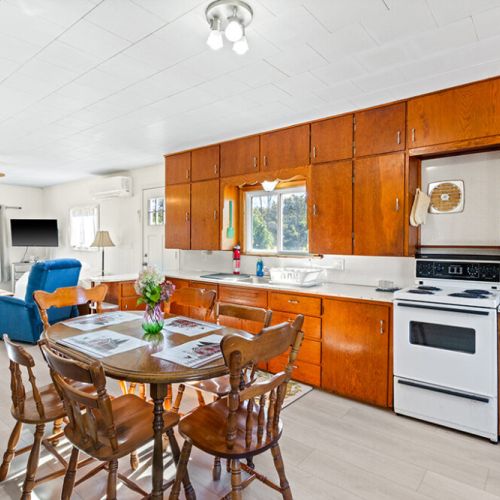 A classic farmhouse kitchen with plenty of cabinetry, counter space and everything close at hand for preparing meals.