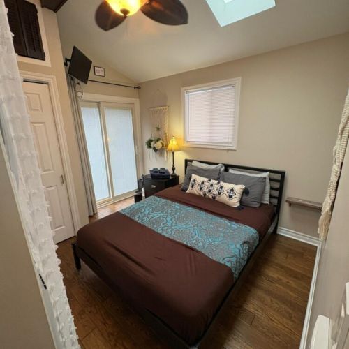 A comfortable queen bedroom with soft lighting and thoughtful décor. Designed for relaxation, privacy, and restful vacation stays.