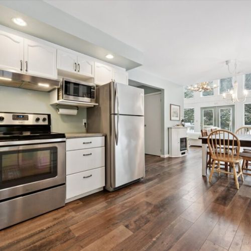 Fully equipped kitchen with stainless steel appliances and open-concept layout