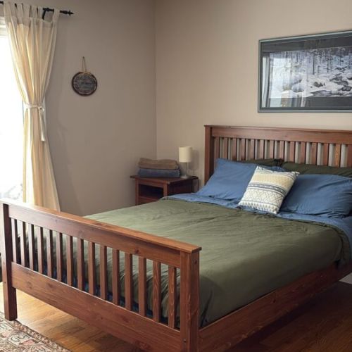 Wake up to breathtaking water views from the ground-level primary suite, conveniently located on the main floor. Step directly onto the deck to soak in the beauty of Georgian Bay and enjoy a seamless connection to the tranquil waterfront setting