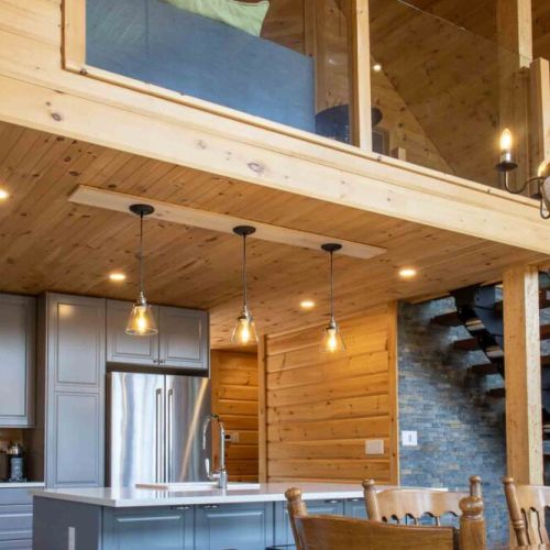 Thoughtful design—modern lighting blends seamlessly with rustic wood and open loft views.