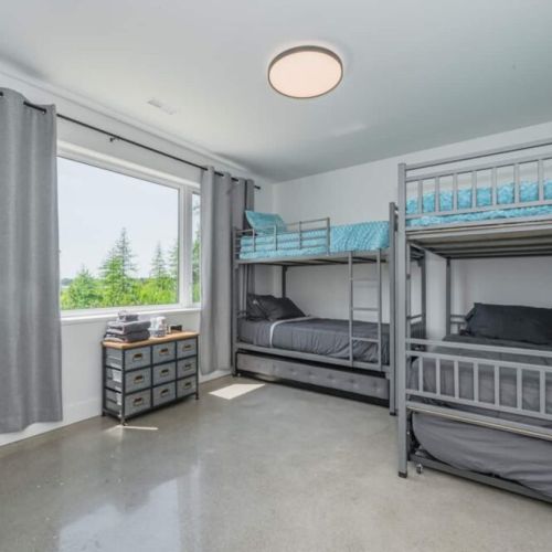 Aqua-Blue kids room with massive bunk beds and trundle pull-outs, smart phone charging station and alarm clock.