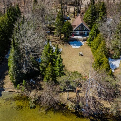 Waterfront vacation rental featuring a large open yard, fire pit, and breathtaking views. Relax by the lake or gather for memorable evenings under the stars!
