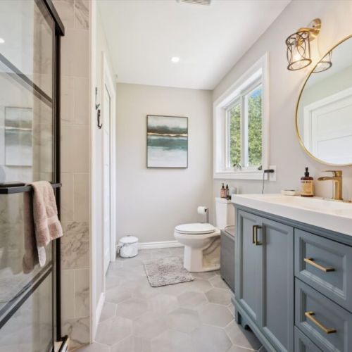 Modern full bathroom with a spacious vanity and walk-in glass shower for a spa-like experience.