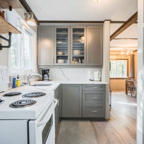Modern appliances make cooking easy, with coffeemaker and kettle.