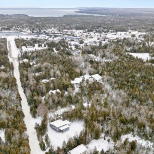 Aerial view of the property surrounded by forest and nature, offering privacy and a true retreat setting.