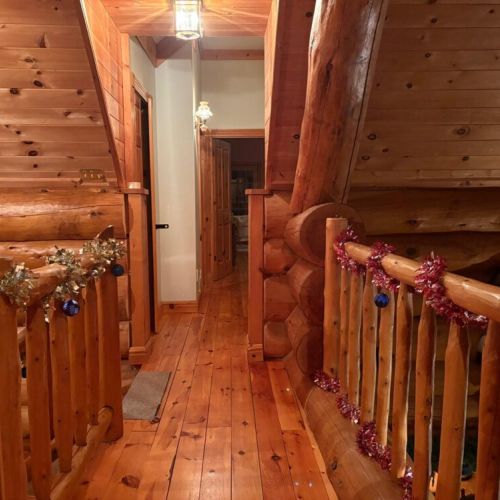 A pine scented walkway wrapped in tinsel and rustic cheer leading to cozy corners