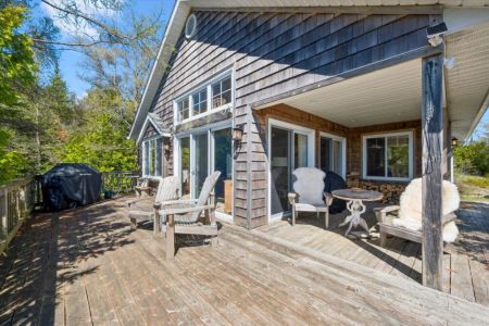 Soak up the sunshine on the spacious wraparound deck, offering plenty of room to relax, barbecue, and enjoy the peaceful surroundings.