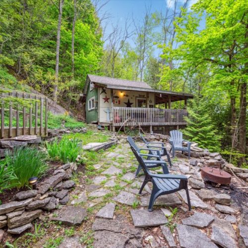 Relax around the natural stone firepit area, perfect for storytelling and s’mores. Nestled among native plantings and backed by serene woods, this is your forest-side retreat.