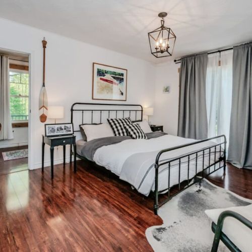 The Master Suite includes a cozy seating nook, walk-in closet, and smart TV—plus private access to the Peninsula Room and hallway.