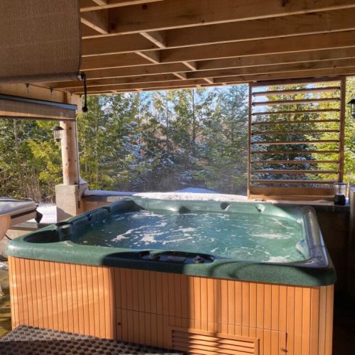 Covered outdoor hot tub at Sunset Villa — seats up to 6 guests comfortably for a relaxing soak year-round.