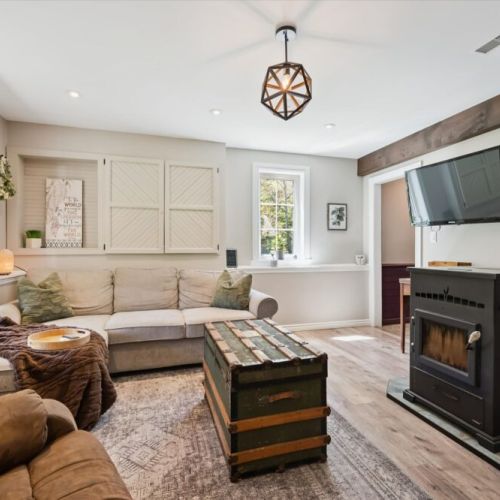 Cozy lounge area featuring a wood stove and TV — perfect for relaxing evenings after exploring.