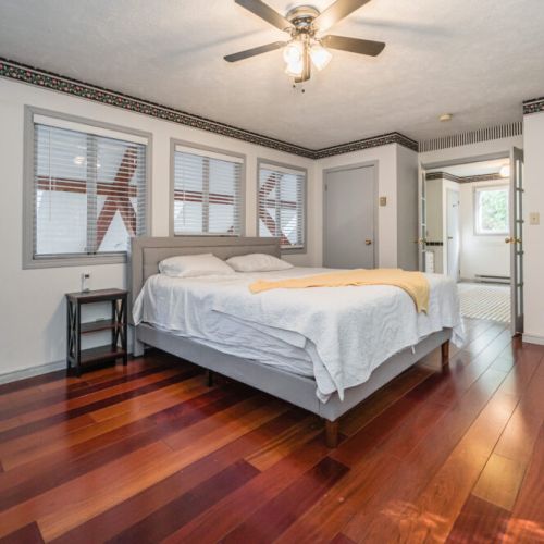 The master bedroom features a king-size bed and ample storage space, perfect for a relaxing night's sleep.