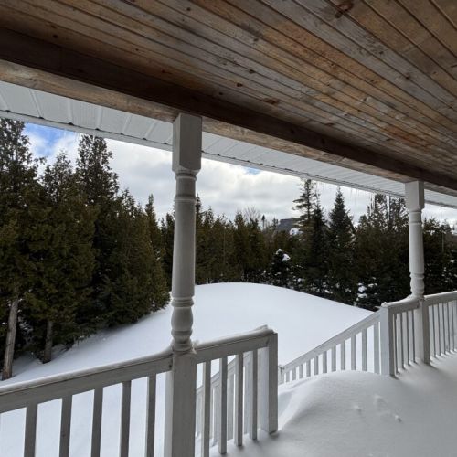 Experience breathtaking snowy landscapes from the covered porch — the perfect winter retreat for a cozy, scenic escape.