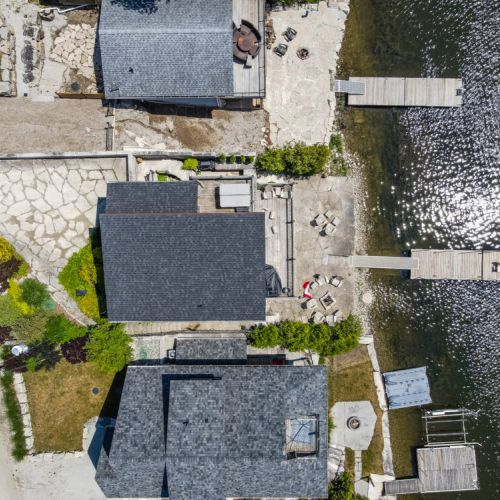 Top-down view showcasing the cottage layout, decks, and waterfront access.