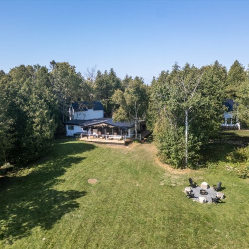 Aerial view showing the huge yard fire pit area and your private waterfront setting.