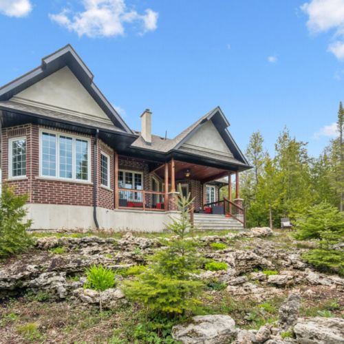 Exterior view surrounded by mature trees, providing privacy and a natural setting