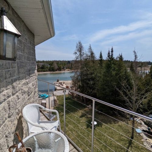Balcony with waterfront and lake views while enjoying morning coffee.