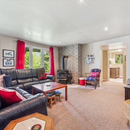 Lower-level family room with comfy sectional seating, wood stove, and a great spot for movies or card nights.