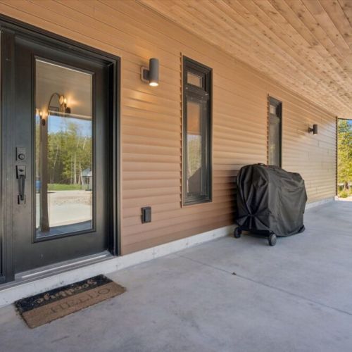 Covered outdoor space with BBQ and room to relax after a day of adventure.
