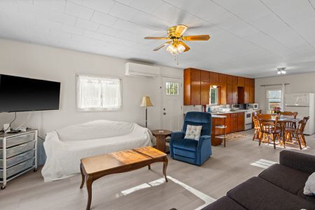 The open-concept living space connects comfortably with the kitchen and dining area, making it easy to spend time together.