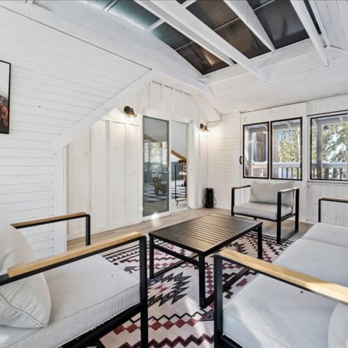 Another view of the screened-in porch seating area—airy, comfortable, and full of natural light. Ideal for morning coffee, board games, or evening downtime.