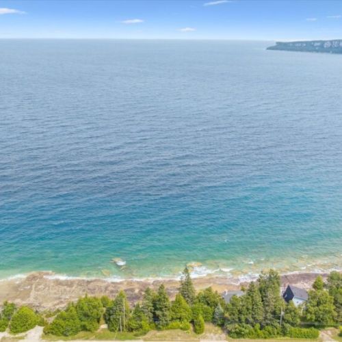 Stunning aerial view of Georgian Bay’s turquoise waters meeting the sky.