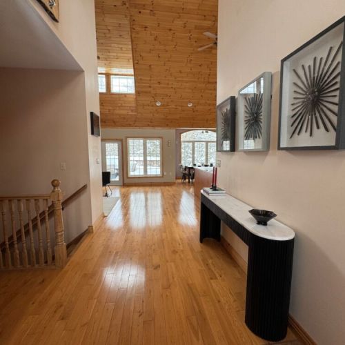 Welcoming entryway leading to an open-concept dining and living area—perfect for group retreats and cozy cottage mornings.