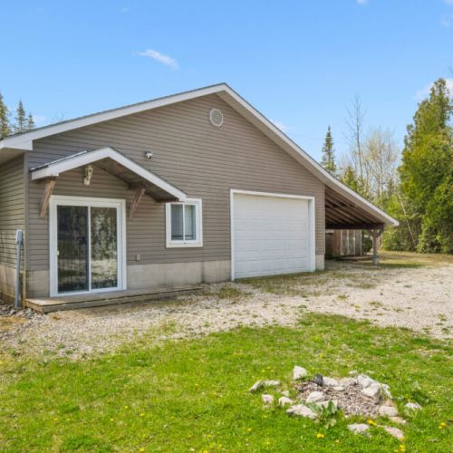 Charming cottage exterior with ample parking and easy access to all outdoor amenities.