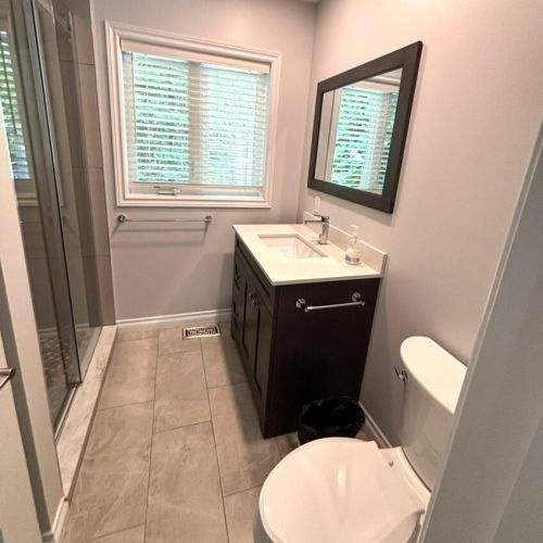 Another beautifully designed bathroom featuring a spacious glass shower and contemporary details.