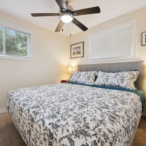 Bedroom 1: Comfortable bedroom with a cozy bed and ceiling fan for a great night’s sleep.