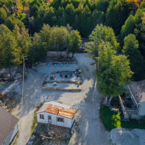 A rustic setting with a picnic table and fire pit, allowing guests to enjoy meals outdoors in a cozy, natural environment.