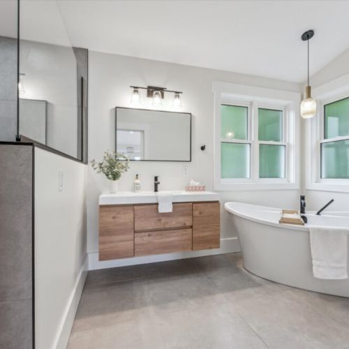 Enjoy a relaxing soak in the freestanding tub or refresh in the walk-in rainfall shower—this modern bathroom is designed for comfort and style.