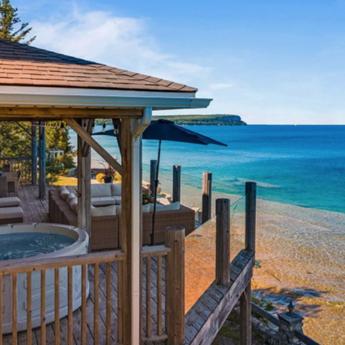 Relax in the private hot tub and lounge on the spacious deck, complete with comfortable seating and glass railings that provide an unobstructed view of Georgian Bay.