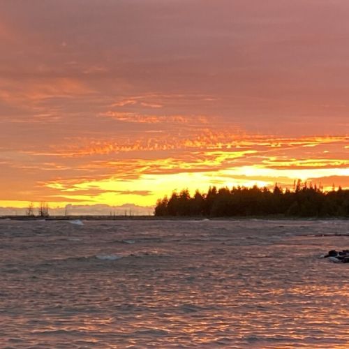 Witness breathtaking Lake Huron sunsets with vibrant skies and tranquil waters—ideal for your next lakeside getaway.