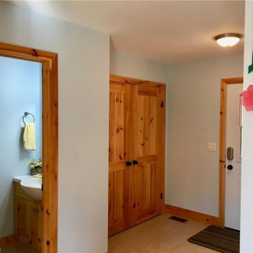 The entryway provides a welcoming arrival space with convenient storage for coats and gear.